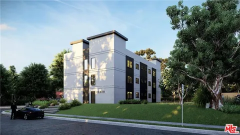 a city street lined with buildings and trees