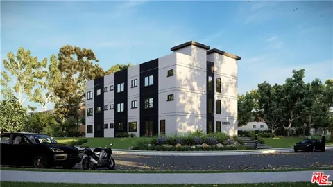 a couple of cars parked in front of a building
