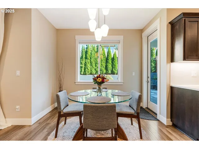 a dining room with furniture a chandelier and wooden floor