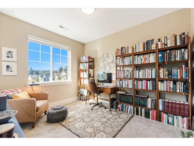 a living room with furniture and a book shelf