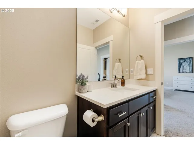 a bathroom with a sink a toilet and mirror