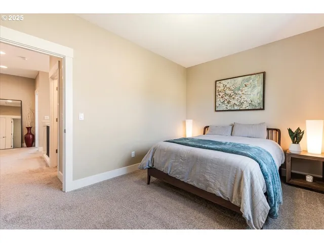 a bedroom with a bed and a painting on the wall