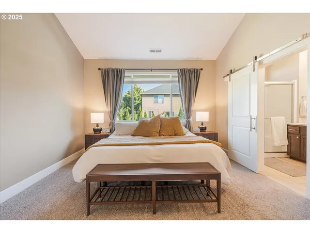 a bed room with a bed a window and a couch