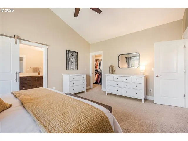 a large bedroom with a bed and a large mirror