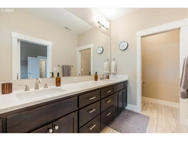 a bathroom with a sink double vanity and a mirror
