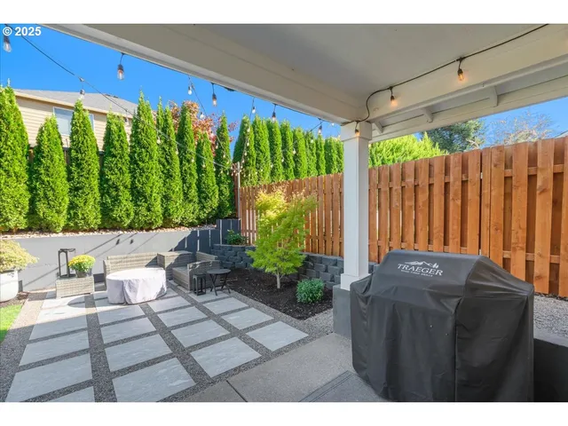 a view of a patio with table and chairs and potted plants