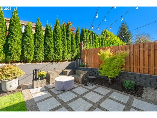 a view of a chairs and table in a backyard