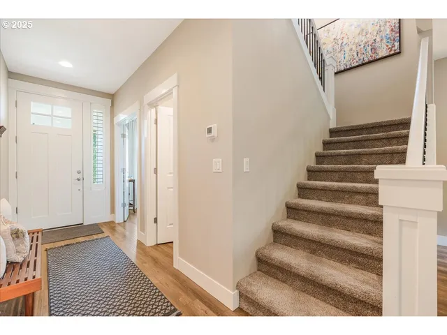 a view of an entryway with wooden floor