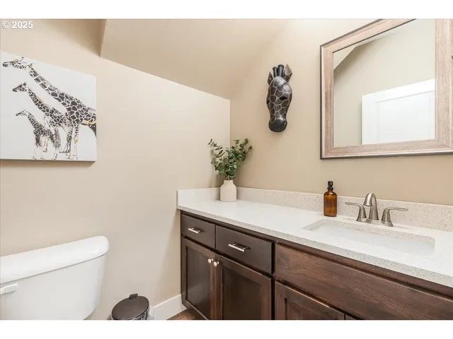 a bathroom with a sink a toilet and mirror