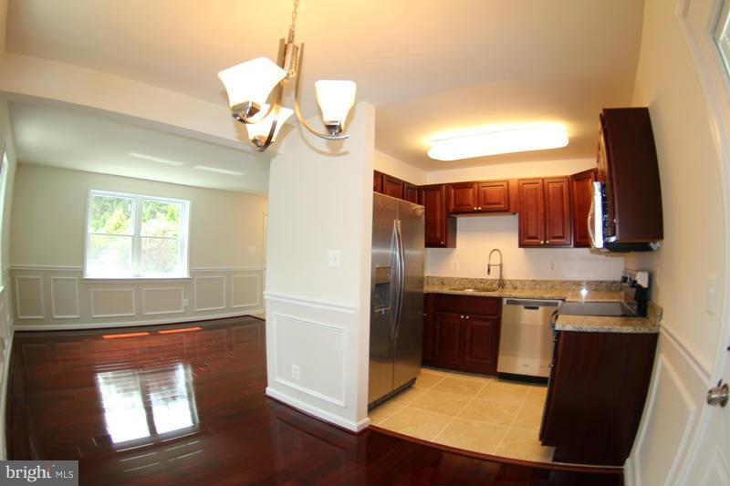 2611 Harris Avenue Silver Spring, MD 20902 - Photo 11 of 30 a kitchen with stainless steel appliances granite countertop a sink a stove and a refrigerator