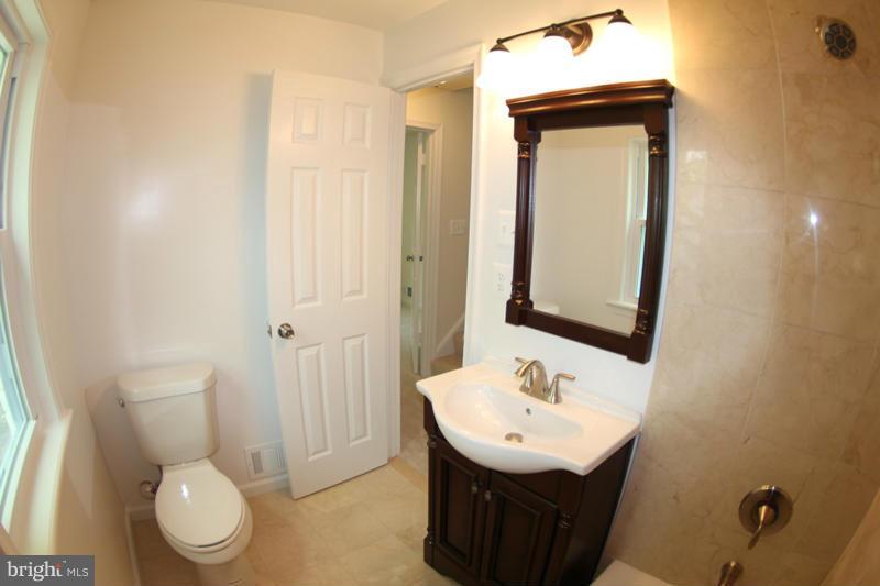2611 Harris Avenue Silver Spring, MD 20902 - Photo 26 of 30 a bathroom with a toilet sink and mirror