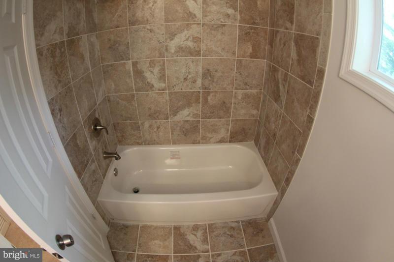 2611 Harris Avenue Silver Spring, MD 20902 - Photo 28 of 30 a bath tub sitting next to a white sink