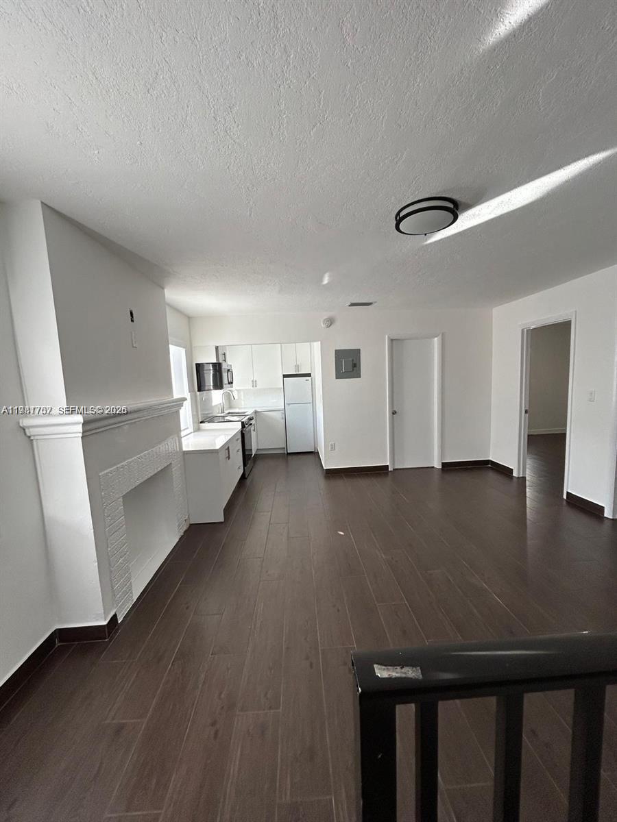 1810 Northwest 34th Street, Unit 2 Miami, FL 33142 - Photo 8 of 11 a living room with furniture and wooden floor