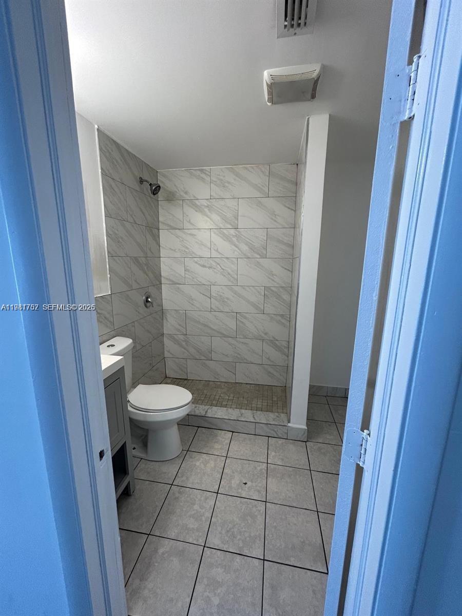 1810 Northwest 34th Street, Unit 2 Miami, FL 33142 - Photo 10 of 11 a bathroom with a toilet and a shower