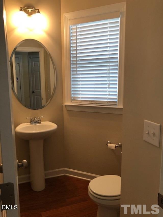 2006 Fieldhouse Avenue Raleigh, NC 27603 - Photo 5 of 8 a bathroom with a toilet sink and mirror