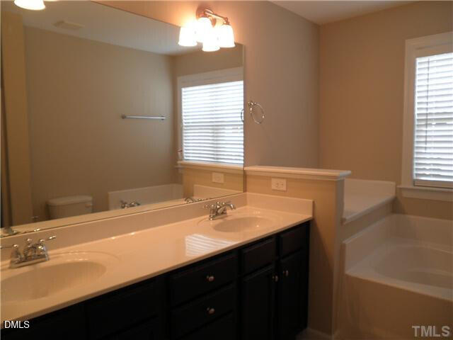 2006 Fieldhouse Avenue Raleigh, NC 27603 - Photo 6 of 8 a bathroom with a sink and a bathtub