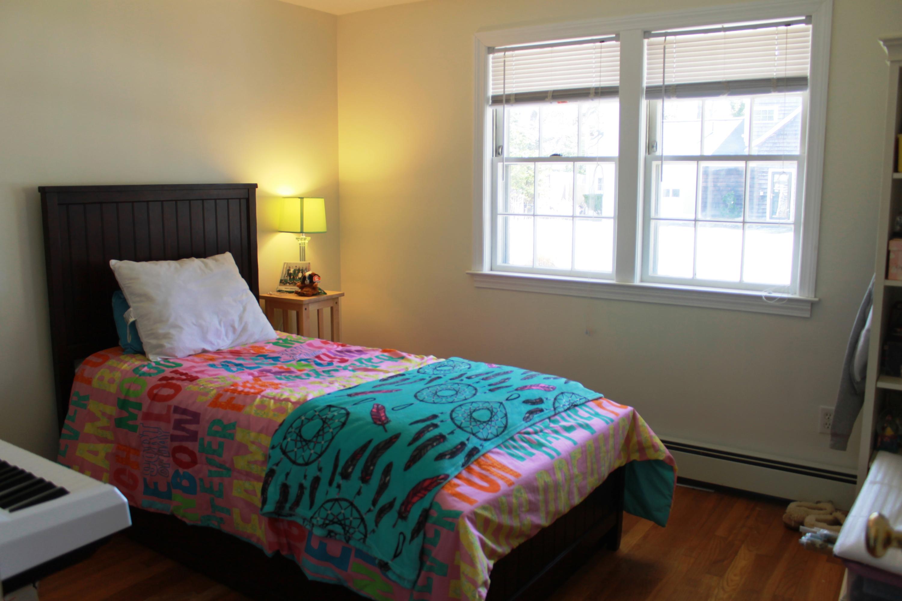 5 Juniper Road Centerville, MA 02632 - Photo 9 of 26 a bedroom with a bed a dresser next to a window
