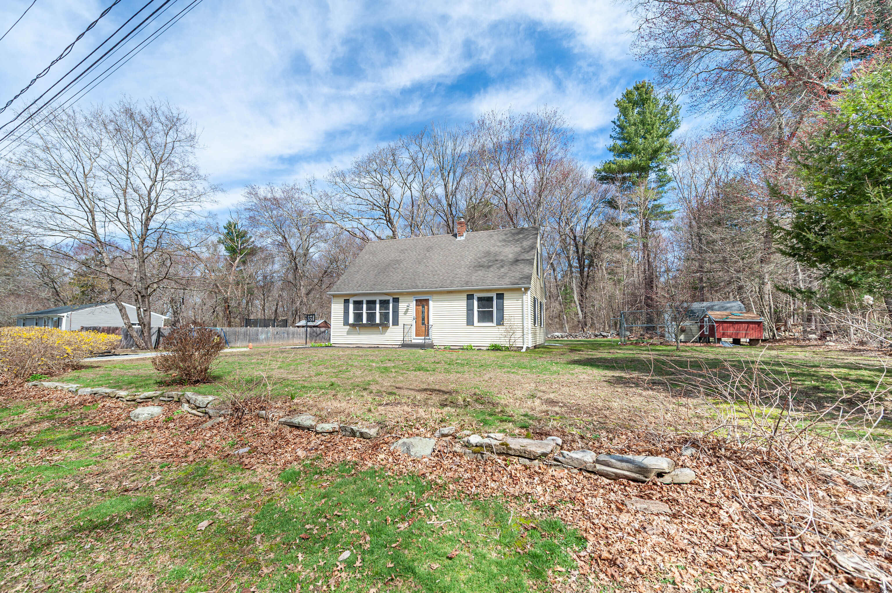a front view of a house with a yard and trees