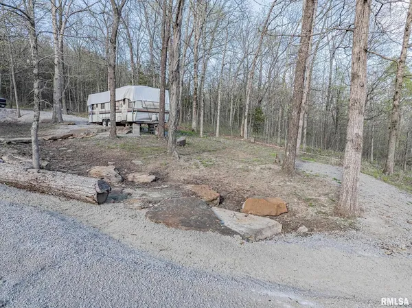 a backyard of a house with barbeque oven and barbeque oven