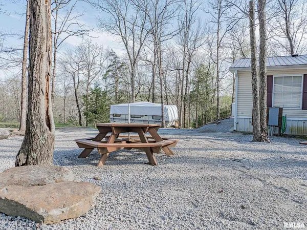 a wooden bench sitting in backyard of a house