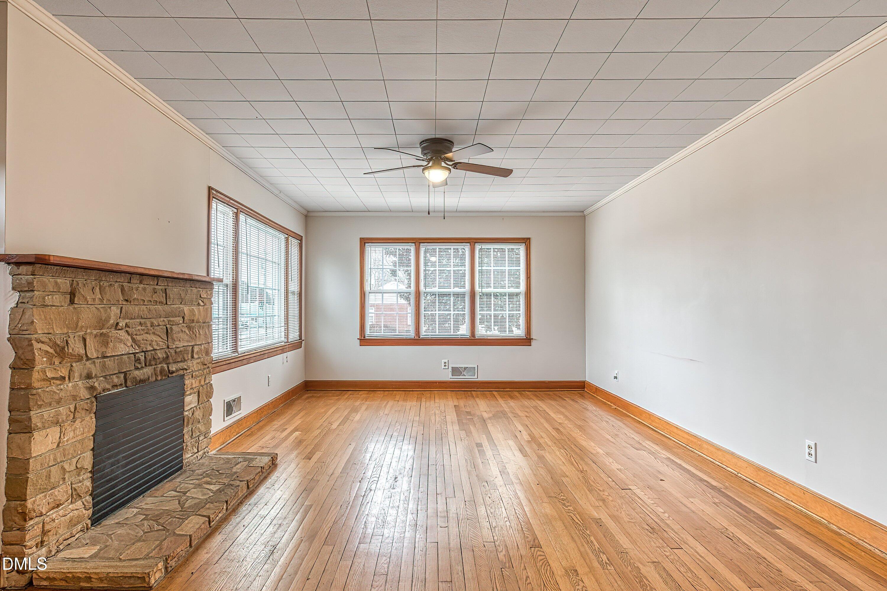 629 East Main Street Clayton, NC 27520 - Photo 11 of 39 a view of an empty room with a window and wooden floor