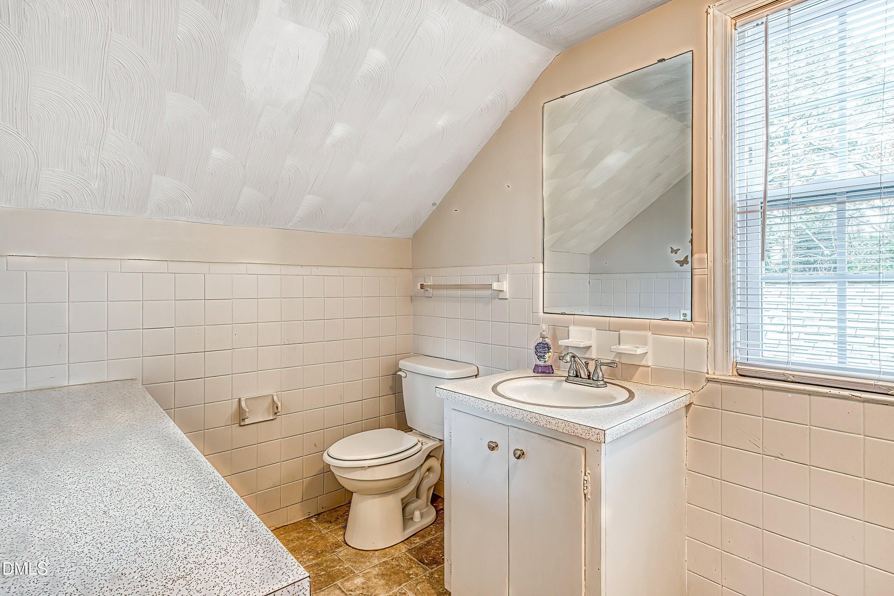 629 East Main Street Clayton, NC 27520 - Photo 32 of 39 a bathroom with a sink toilet and mirror