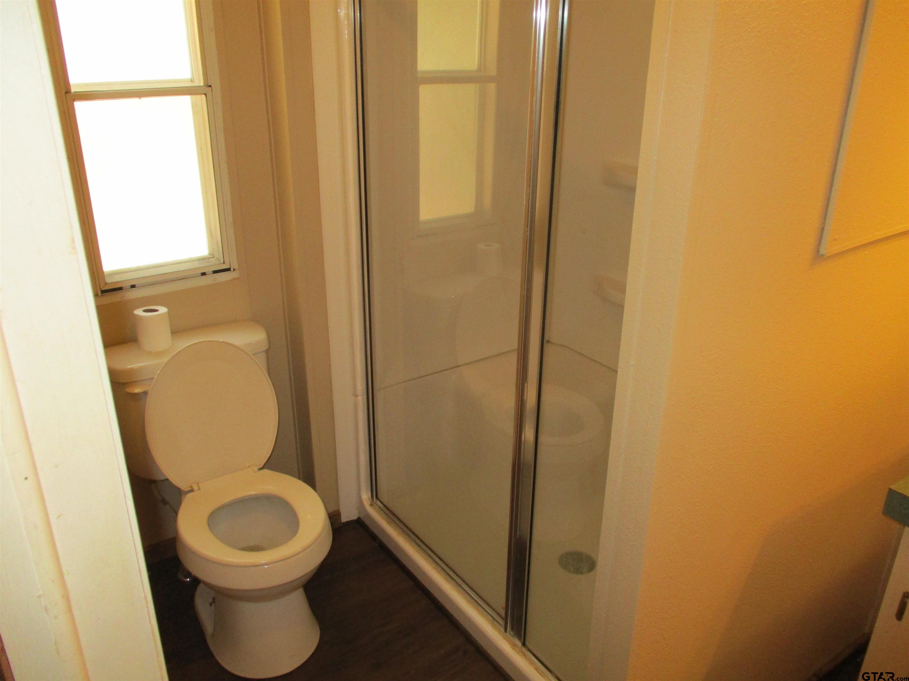105 Sioux Lane Longview, TX 75603 - Photo 13 of 22 a white toilet sitting next to a shower