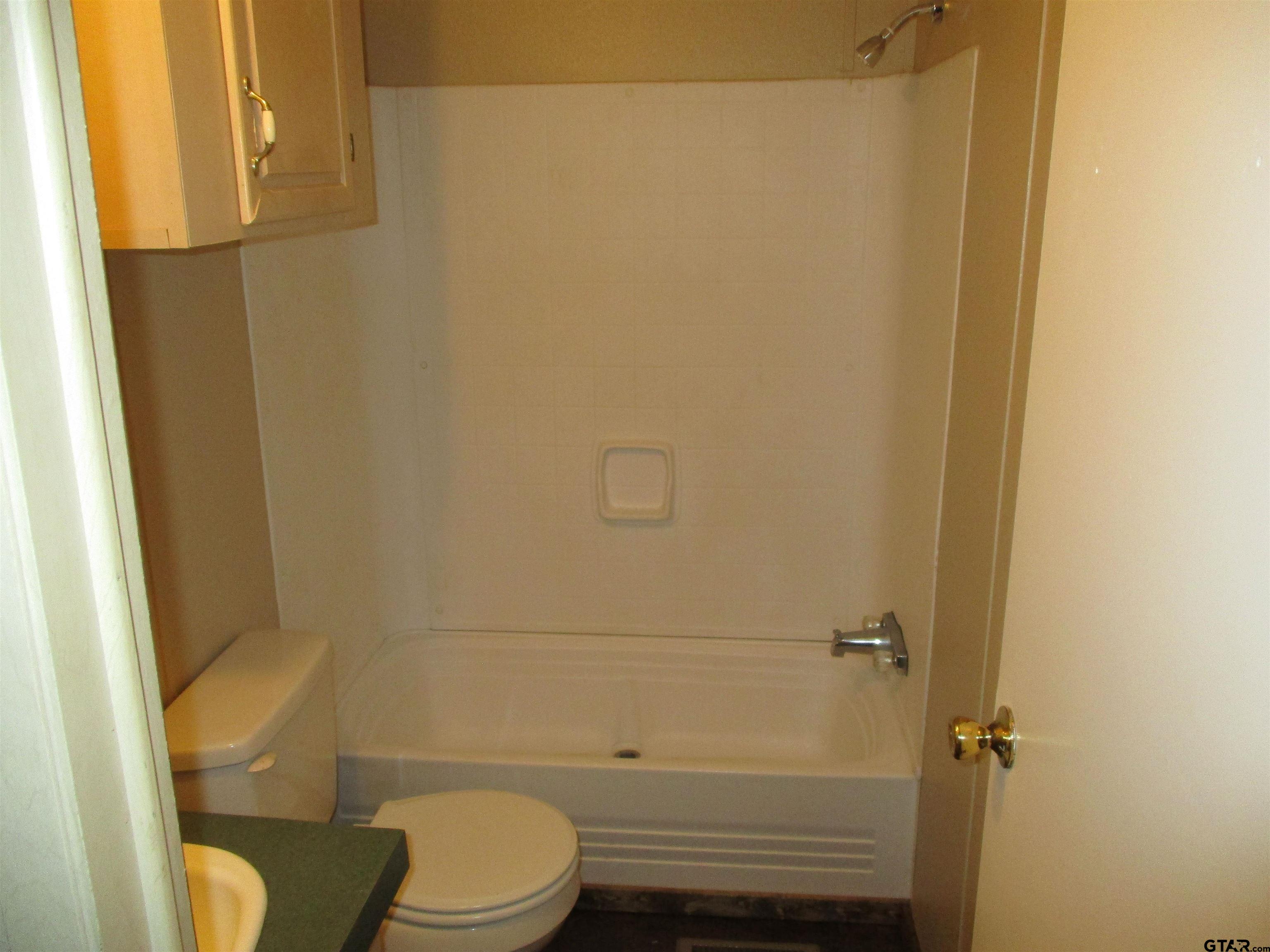 105 Sioux Lane Longview, TX 75603 - Photo 18 of 22 a bathroom with a toilet and a shower
