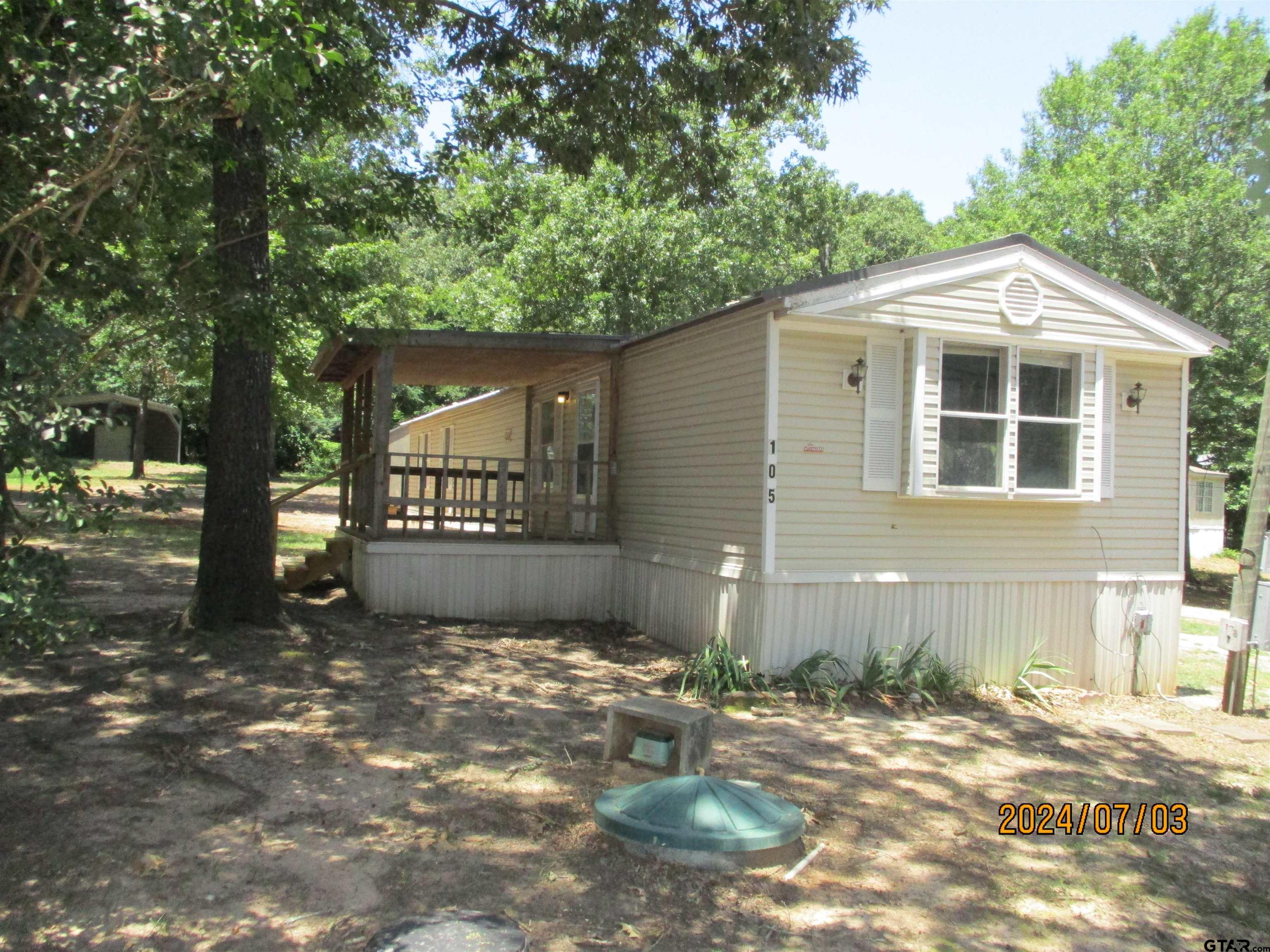 105 Sioux Lane Longview, TX 75603 - Photo 2 of 22 a front view of a house with a yard and garage