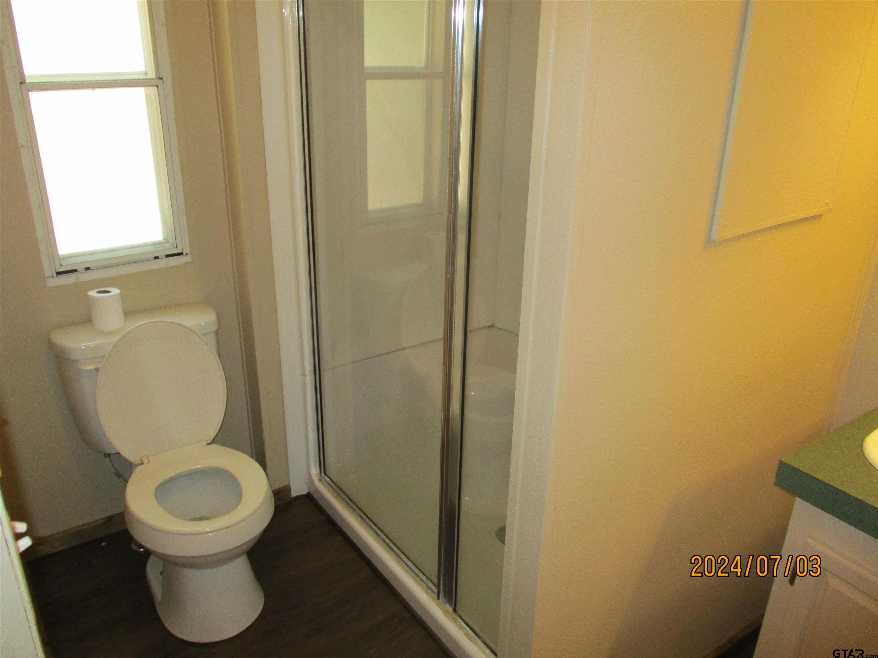 105 Sioux Lane Longview, TX 75603 - Photo 8 of 22 a bathroom with a toilet and a shower