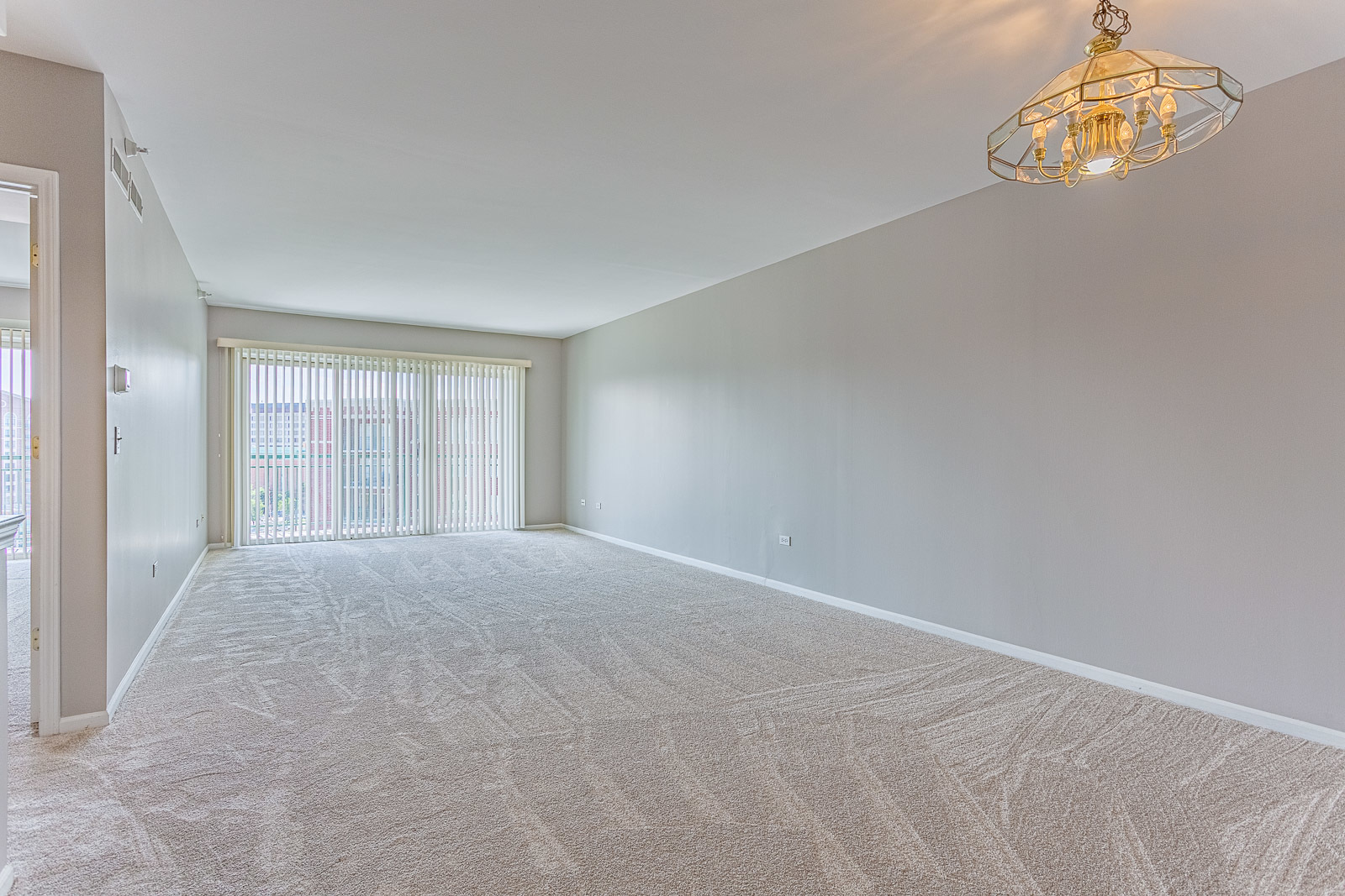 650 South River Road, Unit 807 Des Plaines, IL 60016 - Photo 2 of 16 an empty room with a windows and chandelier