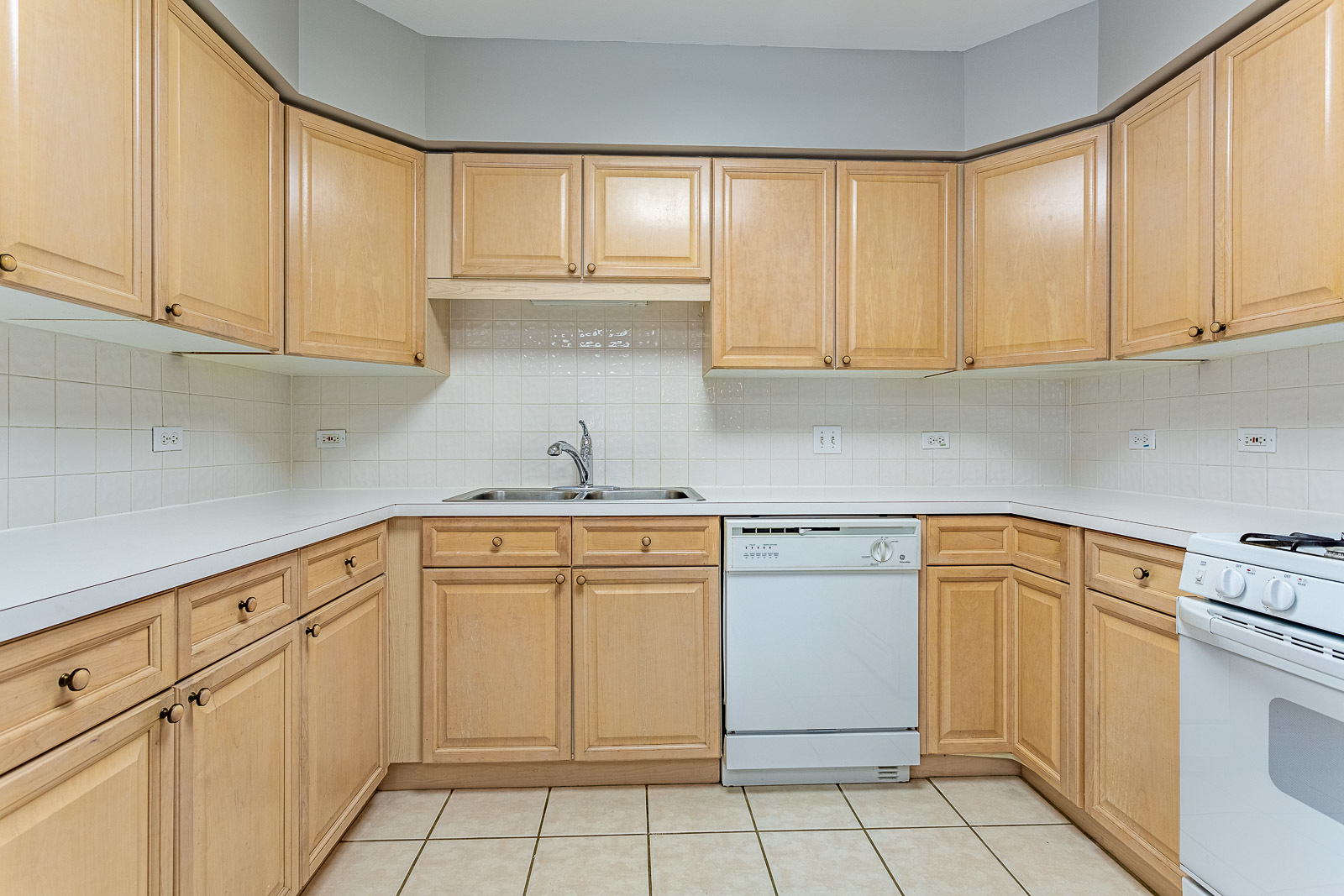 650 South River Road, Unit 807 Des Plaines, IL 60016 - Photo 6 of 16 a kitchen with white cabinets and white appliances