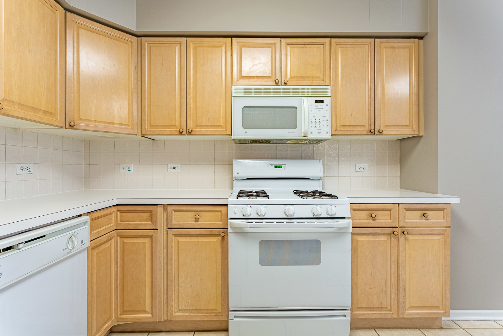 650 South River Road, Unit 807 Des Plaines, IL 60016 - Photo 7 of 16 a kitchen with white cabinets and white appliances