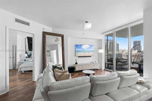a living room with furniture and a chandelier