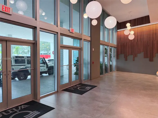 a lobby with furniture and a gym machine