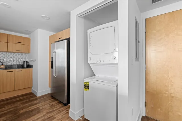 an aerial view of a residential apartment building with a small yard