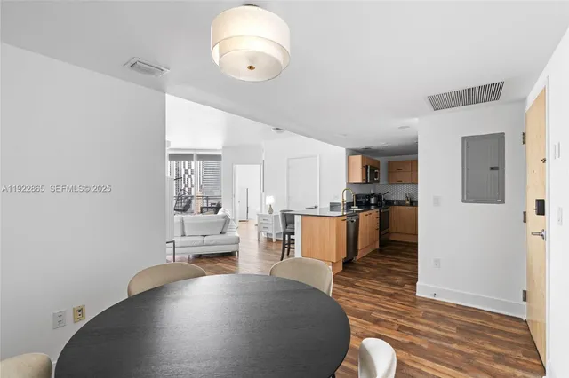a view of a dining room with furniture and a window