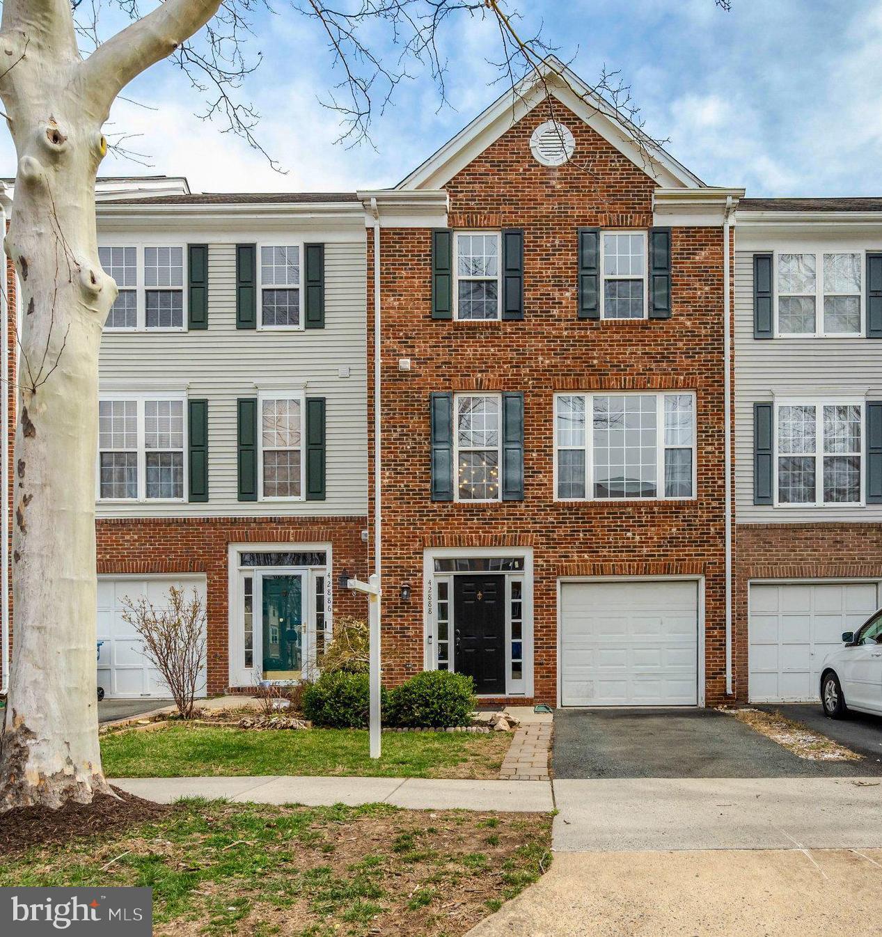 42888 Golf View Drive Chantilly, VA 20152 - Photo 1 of 29 a front view of a house with a yard and garage