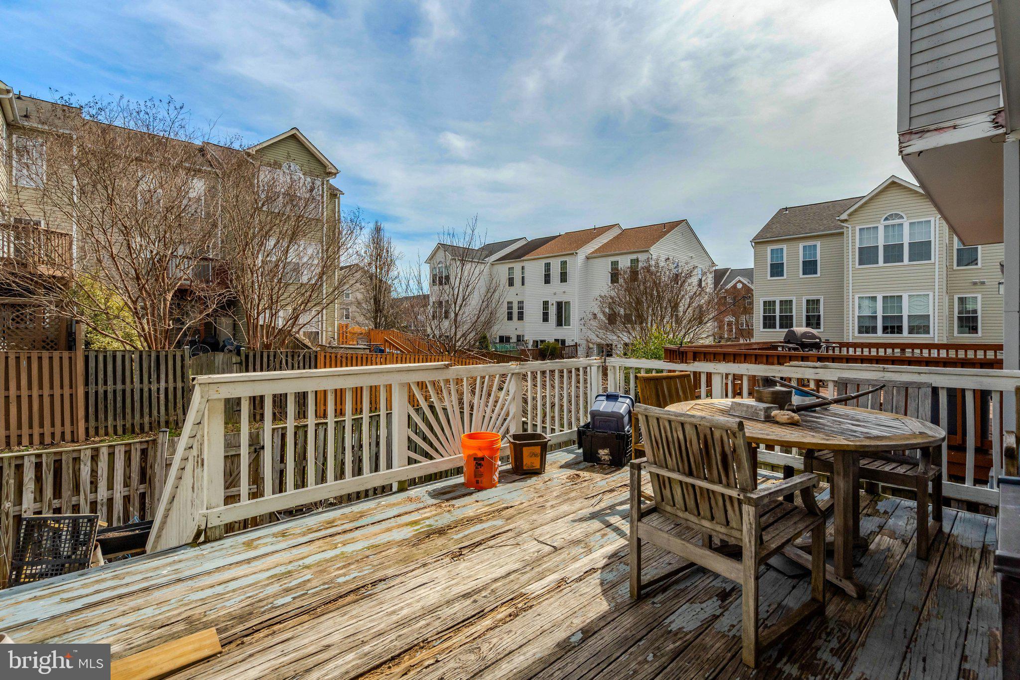 42888 Golf View Drive Chantilly, VA 20152 - Photo 15 of 29 a view of a roof deck with table and chairs and wooden floor