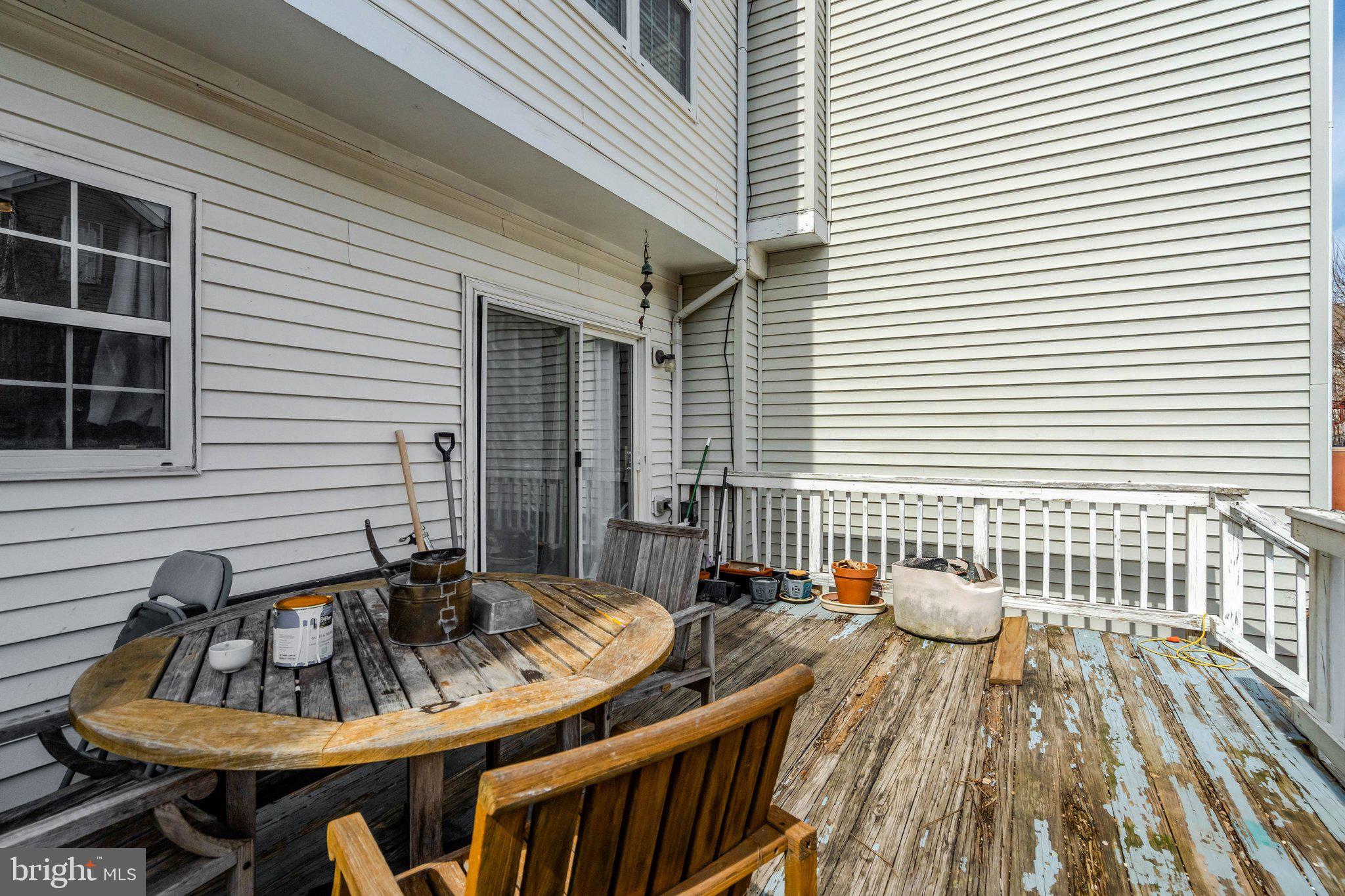 42888 Golf View Drive Chantilly, VA 20152 - Photo 16 of 29 a view of a patio with a table and chairs and wooden floor
