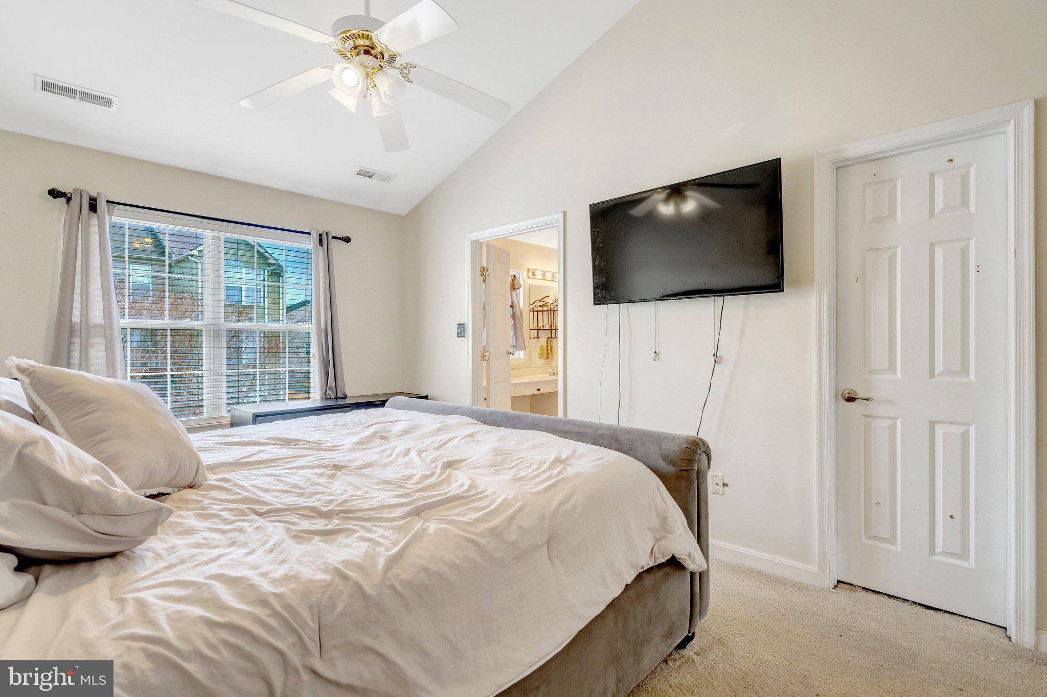 42888 Golf View Drive Chantilly, VA 20152 - Photo 20 of 29 a bedroom with a bed and a flat screen tv