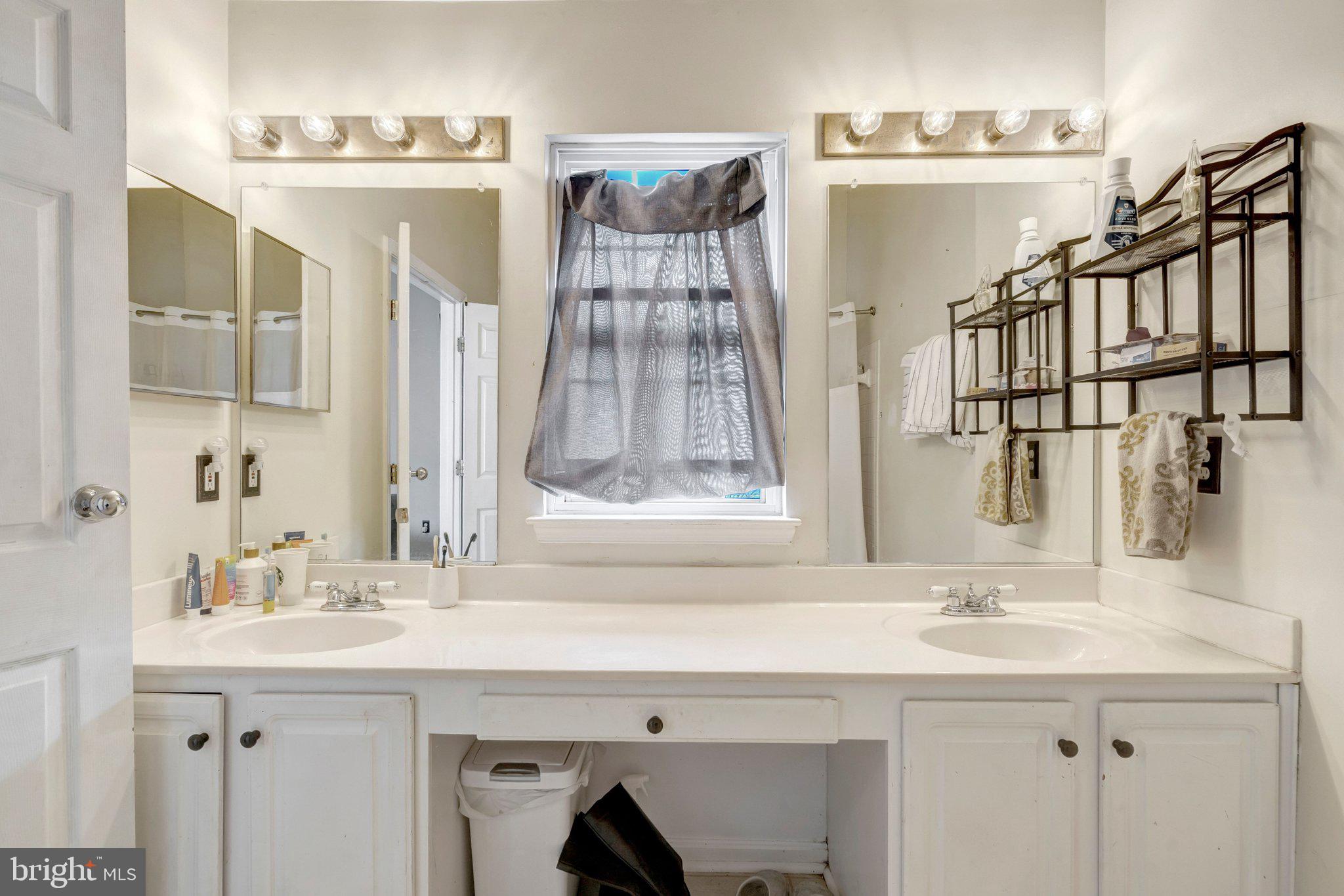 42888 Golf View Drive Chantilly, VA 20152 - Photo 21 of 29 a bathroom with a sink and a mirror