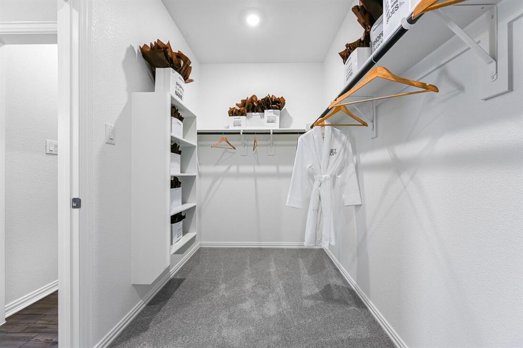 2621 Glacier Road Anna, TX 75409 - Photo 16 of 38 a view of walk in closet with empty racks