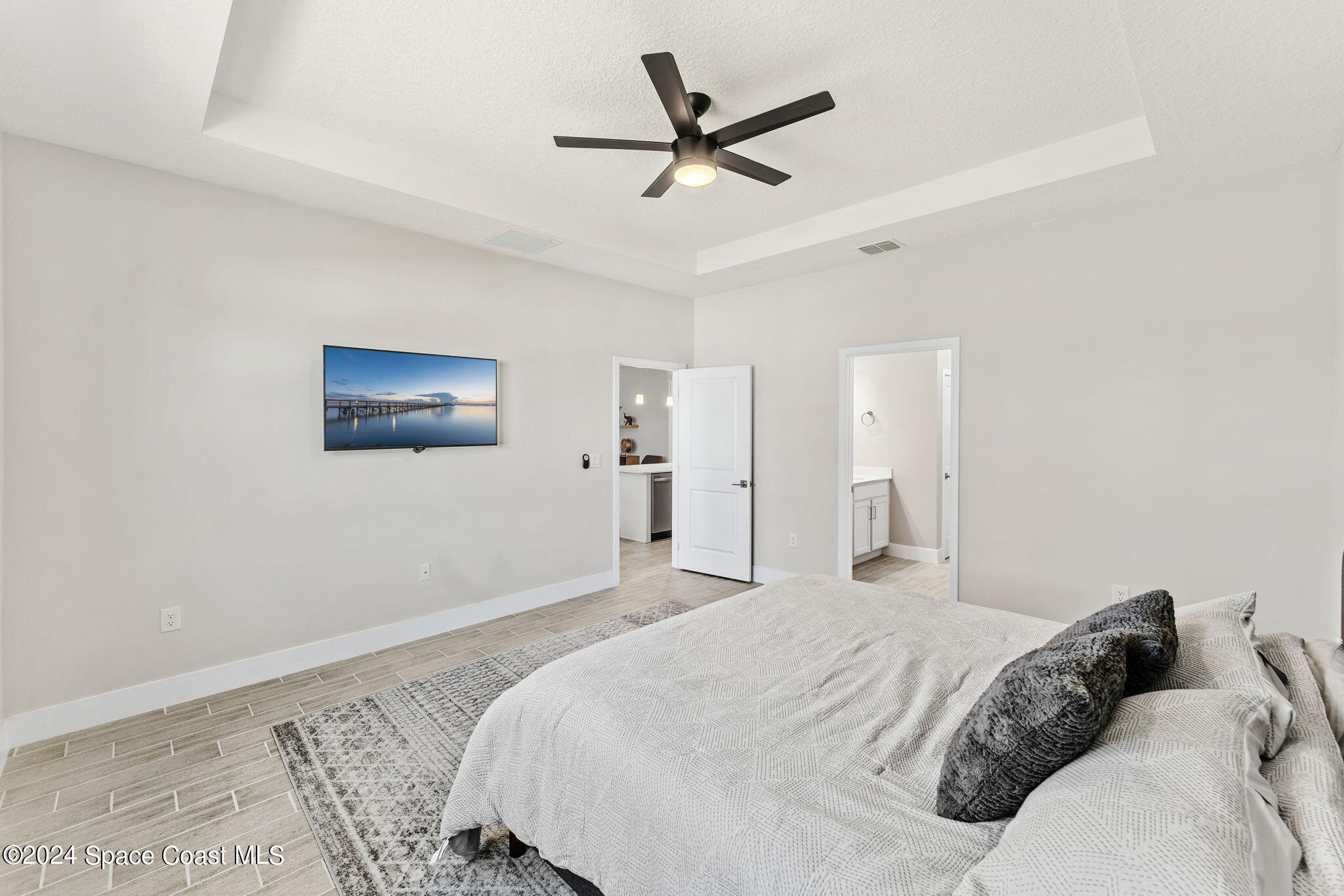 355 Wendover Road Southwest Palm Bay, FL 32908 - Photo 19 of 44 a bedroom with a large bed and a ceiling fan