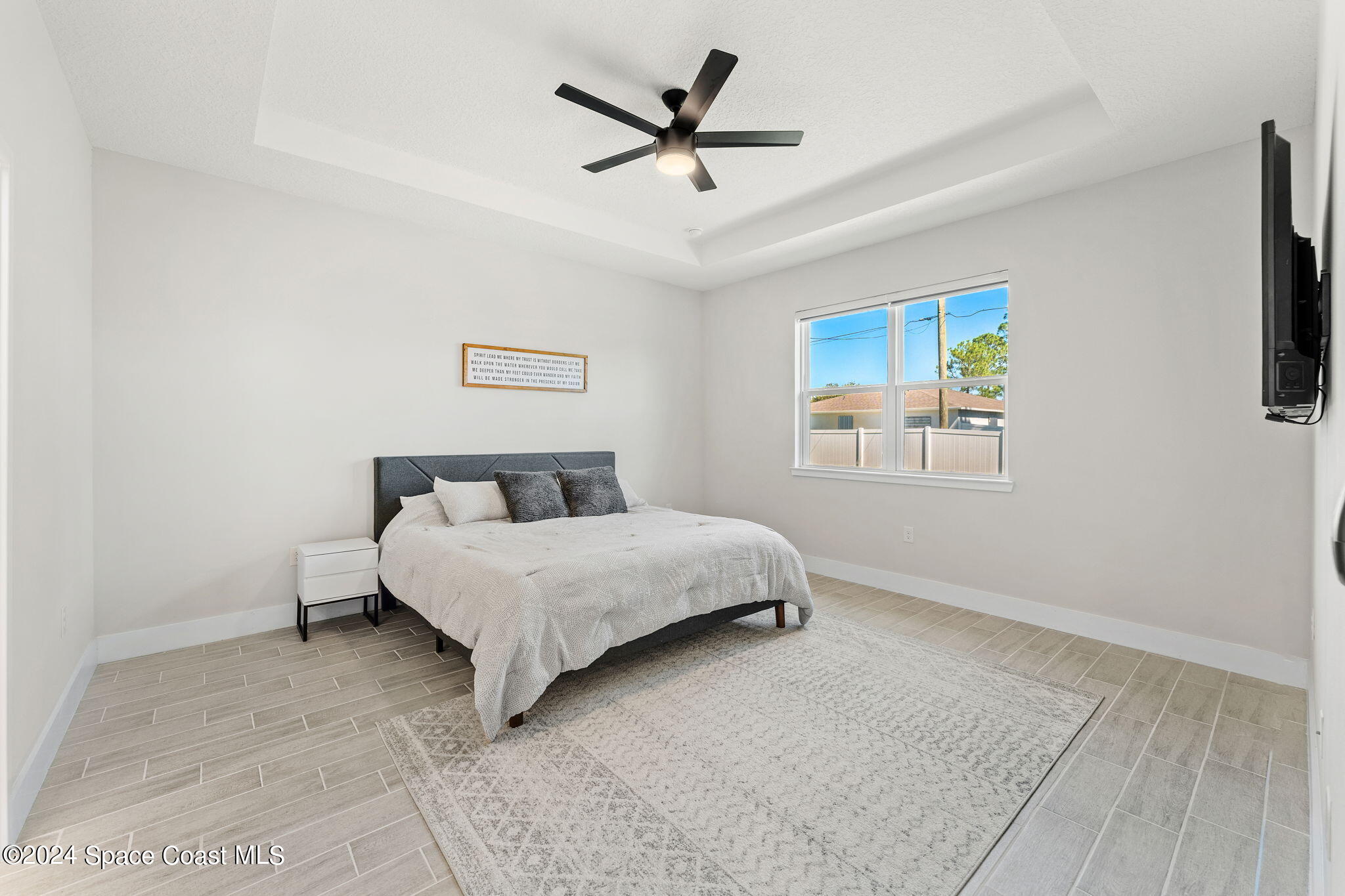 355 Wendover Road Southwest Palm Bay, FL 32908 - Photo 21 of 44 a bedroom with a bed and a ceiling fan