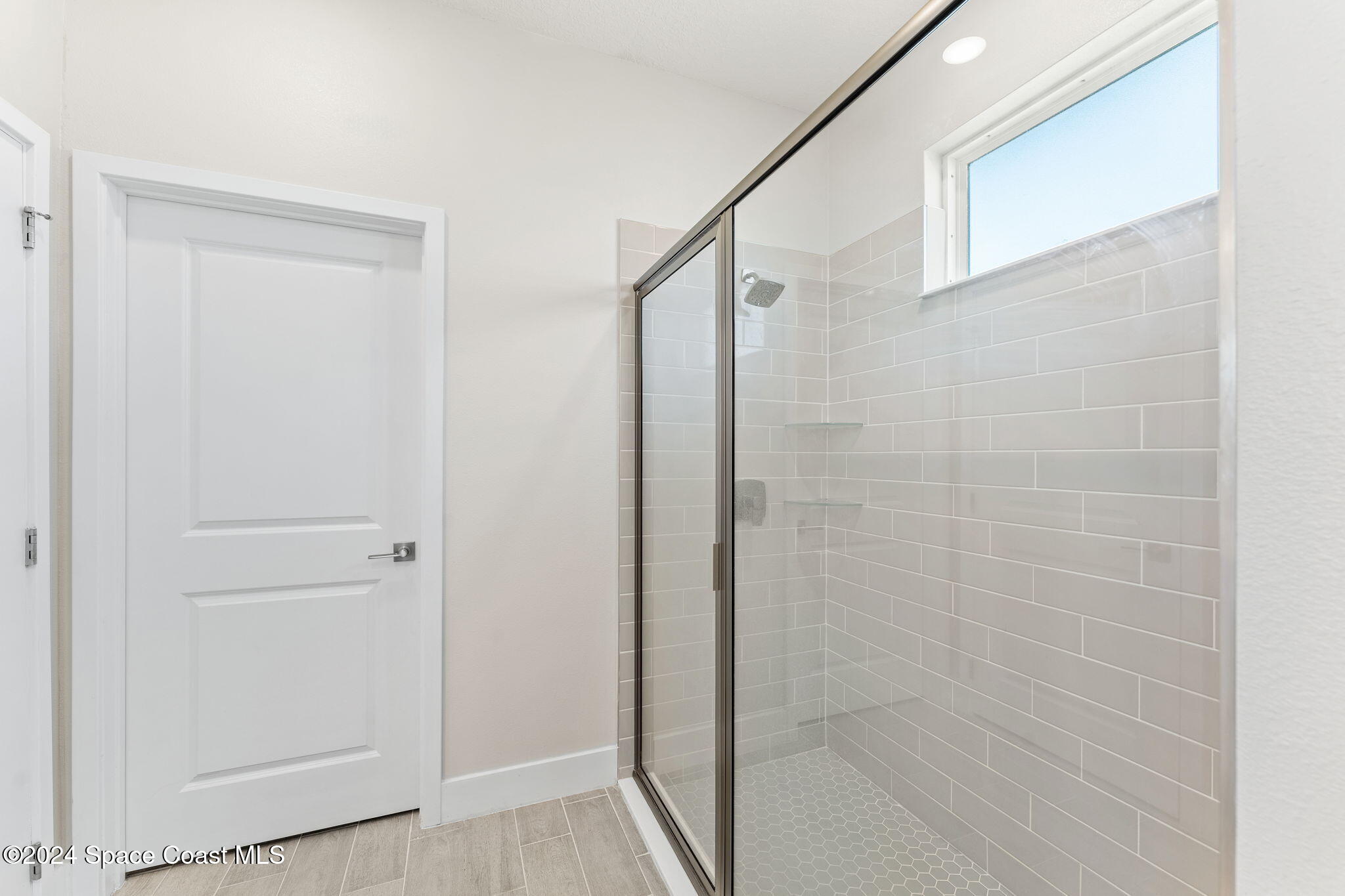 355 Wendover Road Southwest Palm Bay, FL 32908 - Photo 23 of 44 a bathroom with a glass shower door