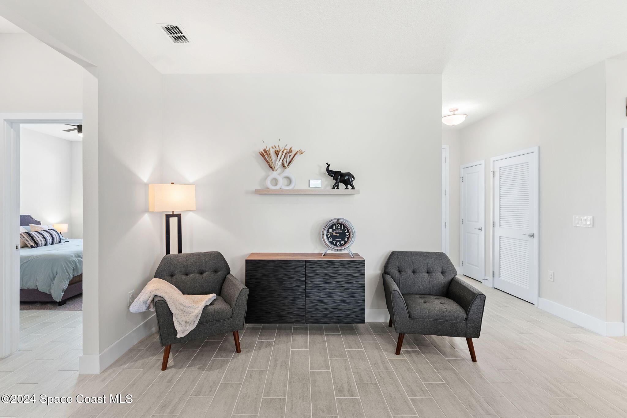 355 Wendover Road Southwest Palm Bay, FL 32908 - Photo 24 of 44 a living room with furniture and a lamp