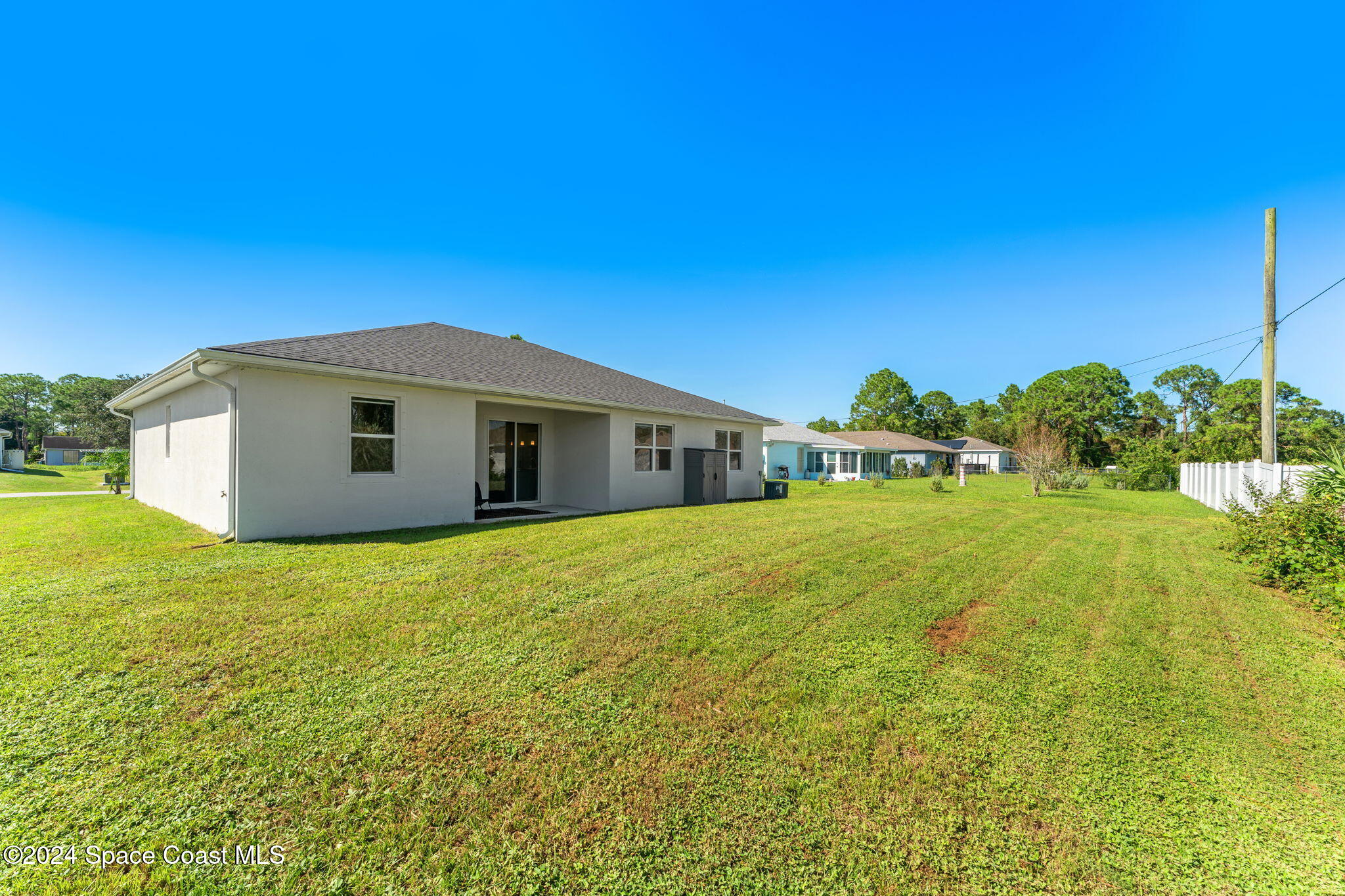 355 Wendover Road Southwest Palm Bay, FL 32908 - Photo 31 of 44 a yellow house with a garden