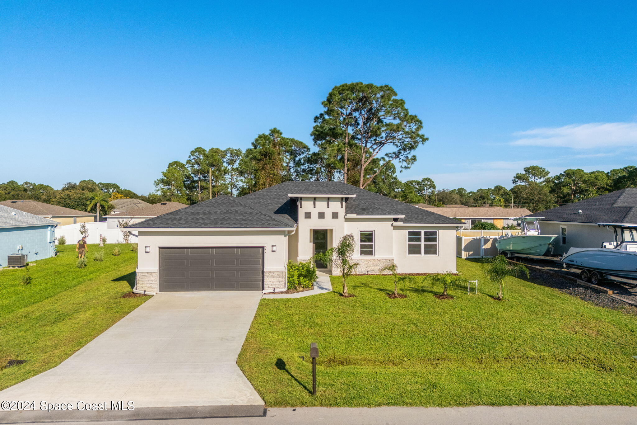 355 Wendover Road Southwest Palm Bay, FL 32908 - Photo 41 of 44 a front view of a house with a yard and garage