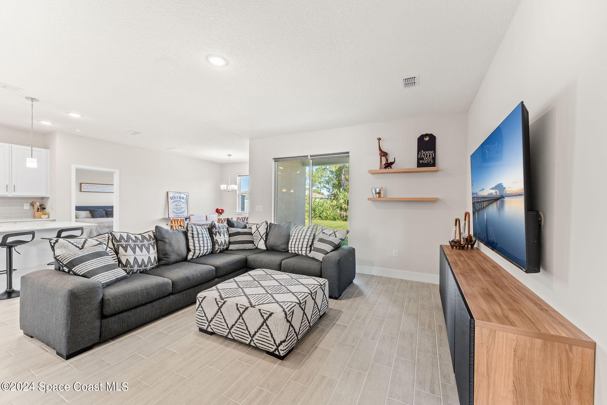 355 Wendover Road Southwest Palm Bay, FL 32908 - Photo 7 of 44 a living room with furniture and a flat screen tv